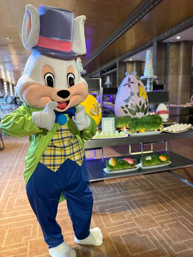 A costumed Easter bunny character in a top hat at a festive Easter brunch